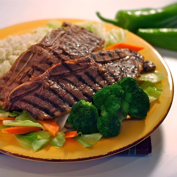Grilled short ribs with rice, broccoli, and mixed vegetables on a yellow plate.